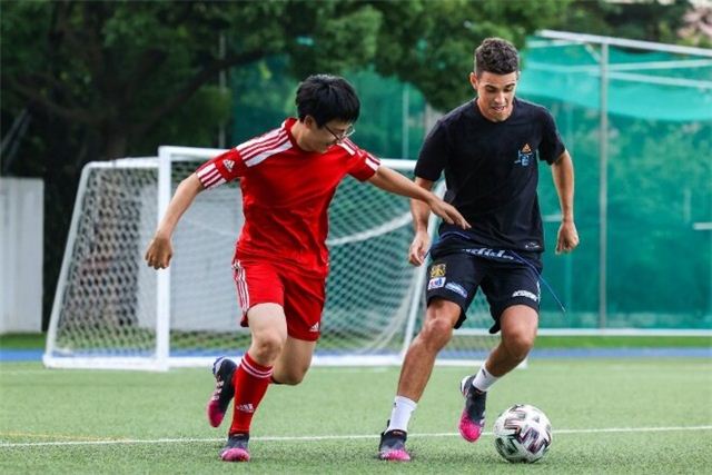 A couple of men playing football

Description automatically generated with medium confidence